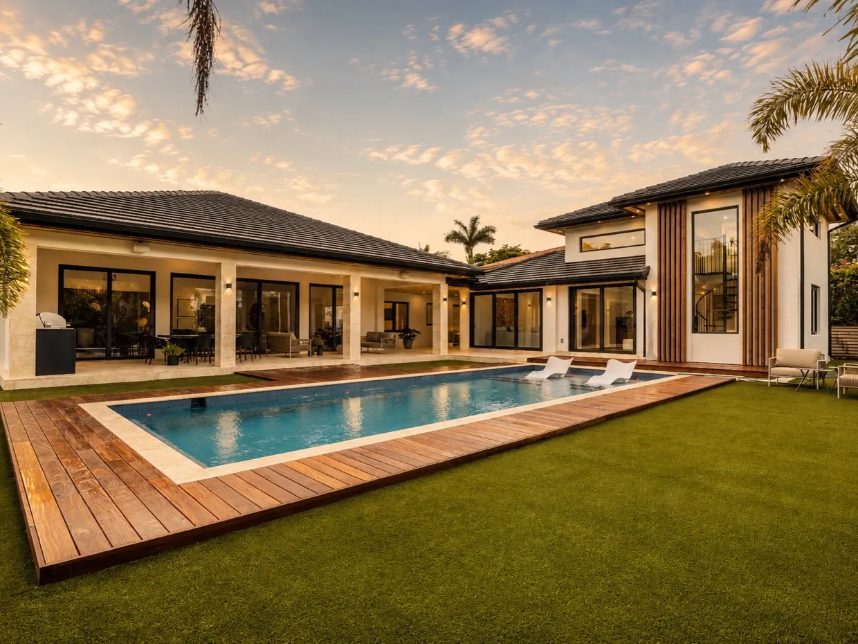 Pool and covered terrace at dusk
